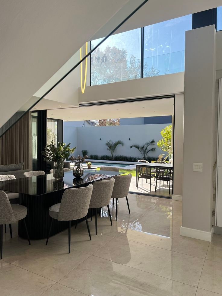 Dining room opening onto a poolside courtyard